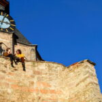 Two people sitting on the wall of Landgrafen Palace in Germany.